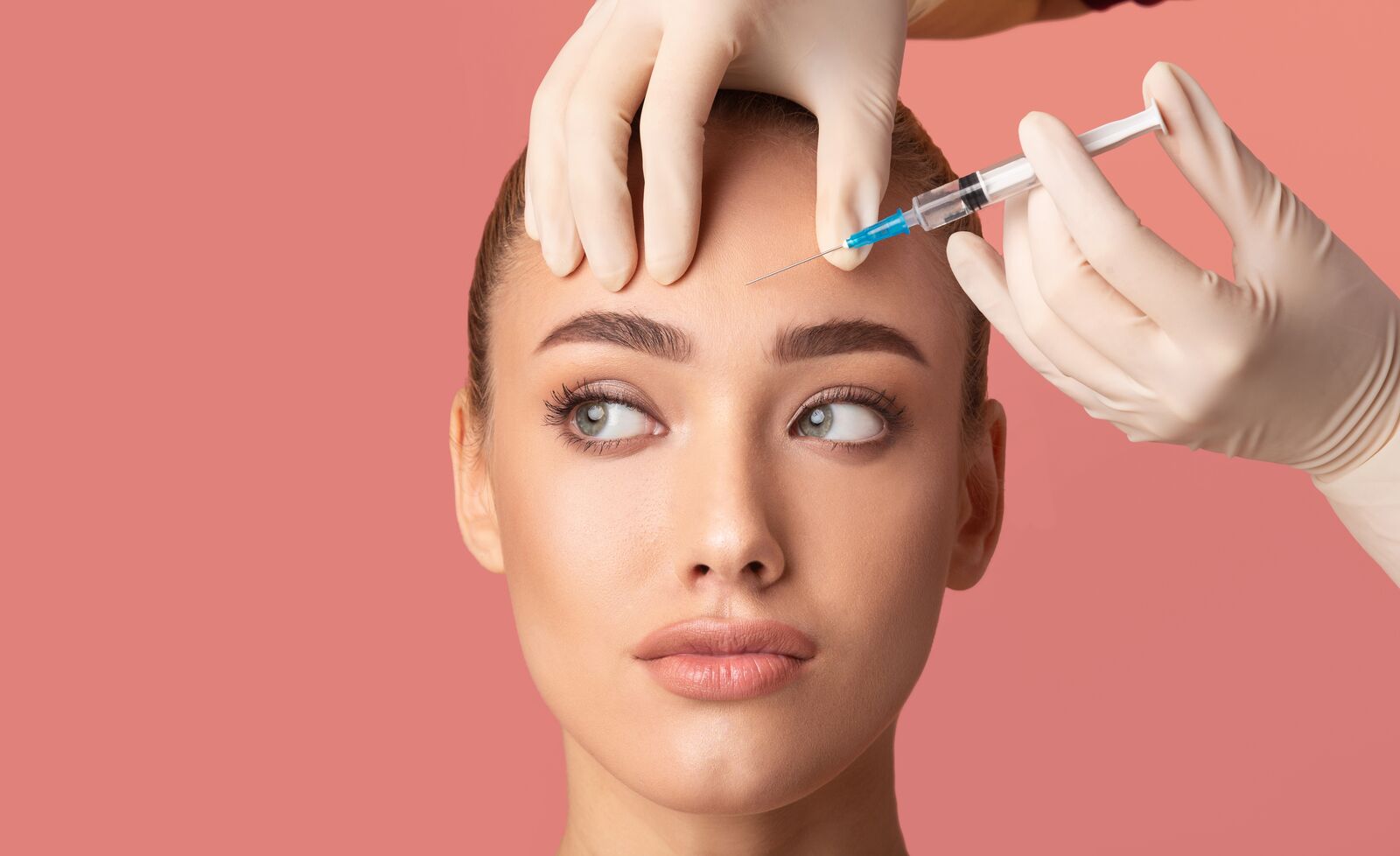 Woman receiving a Botox injection in her forehead