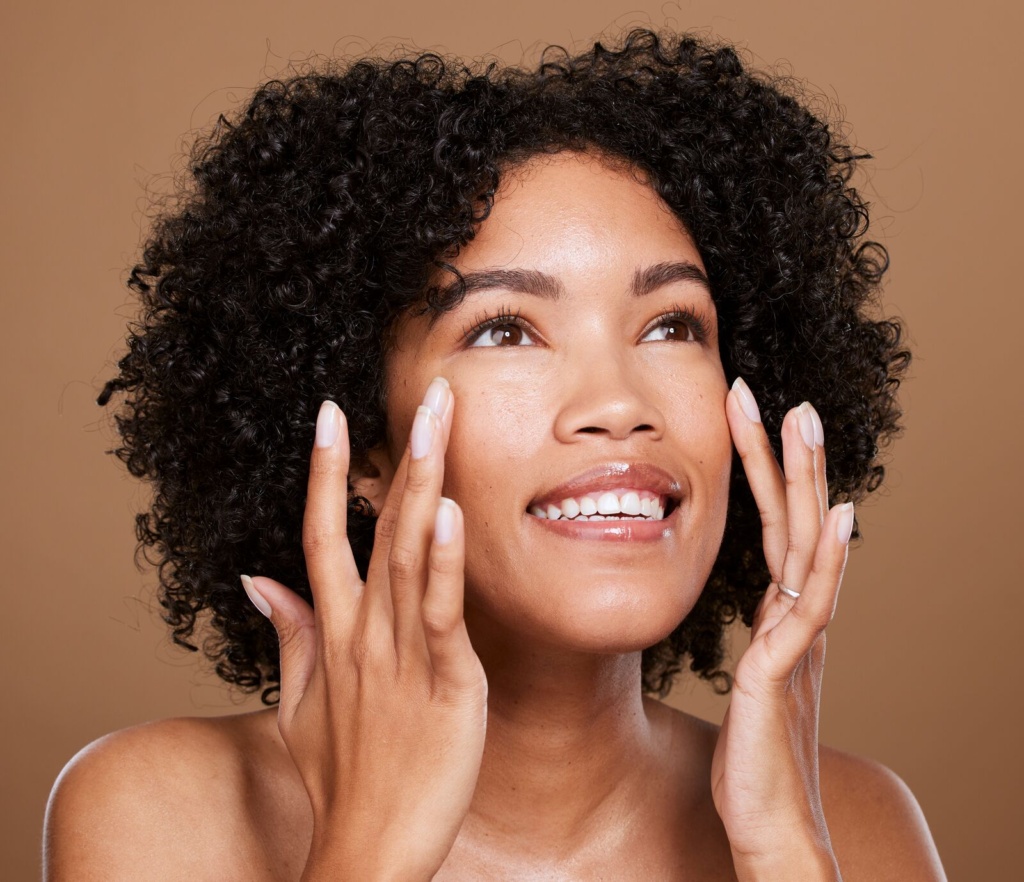 Smiling woman touching her smooth skin after Botox